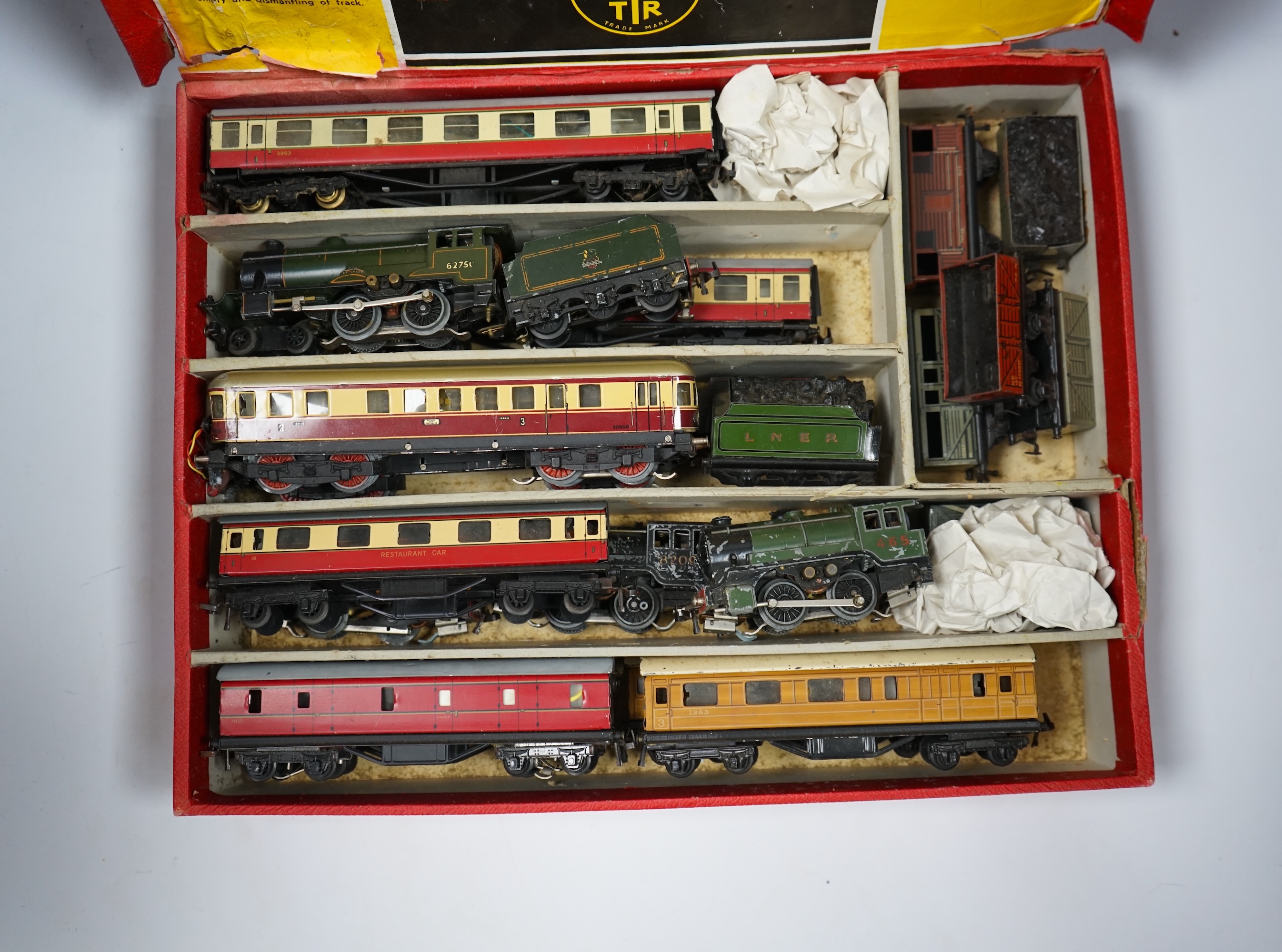 A Trix Twin Railway 00 gauge train set box containing; four locomotives, eight bogie coaches, two railcars, and six freight wagons, together with a live steam Marklin 0-4-0T LNER locomotive. Condition - poor to fair.